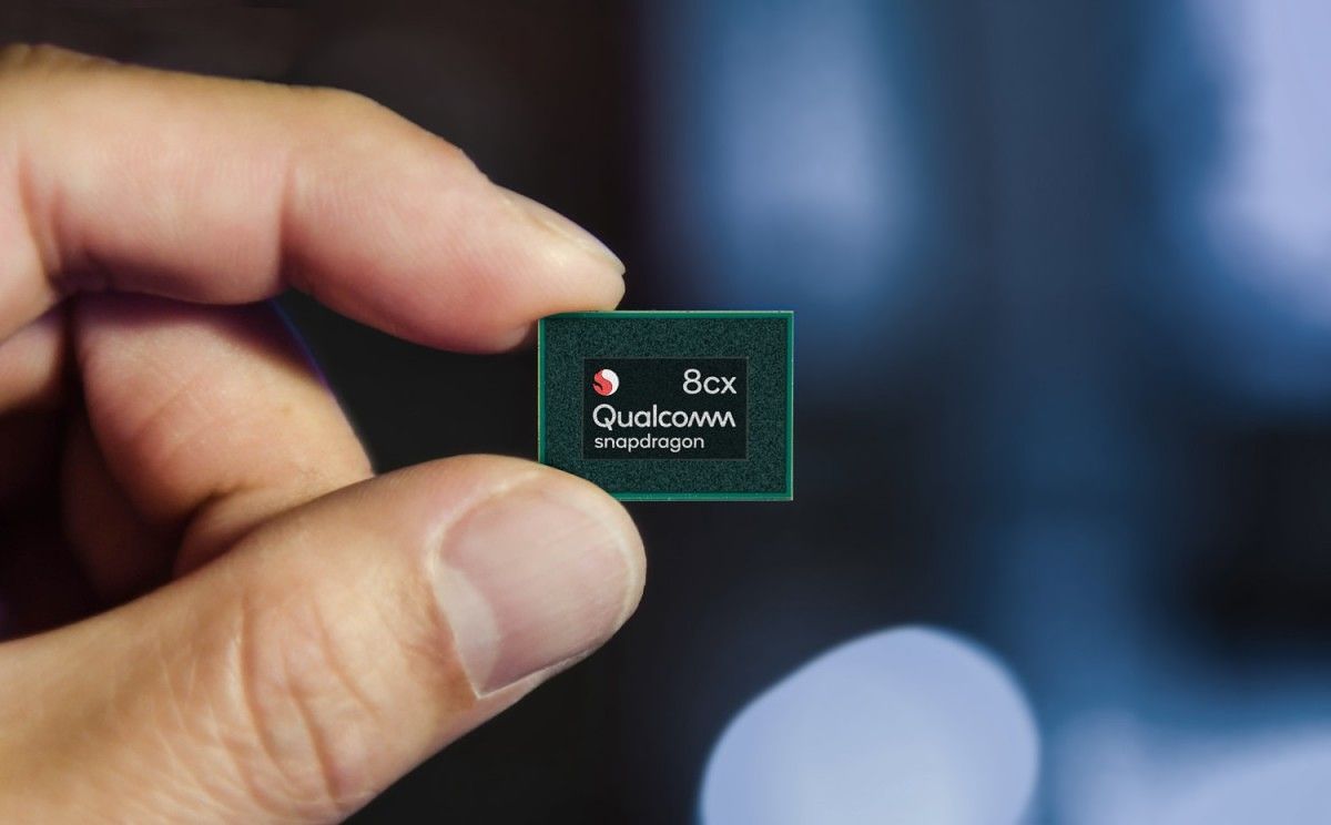A person holding a Snapdragon 8cx chip.