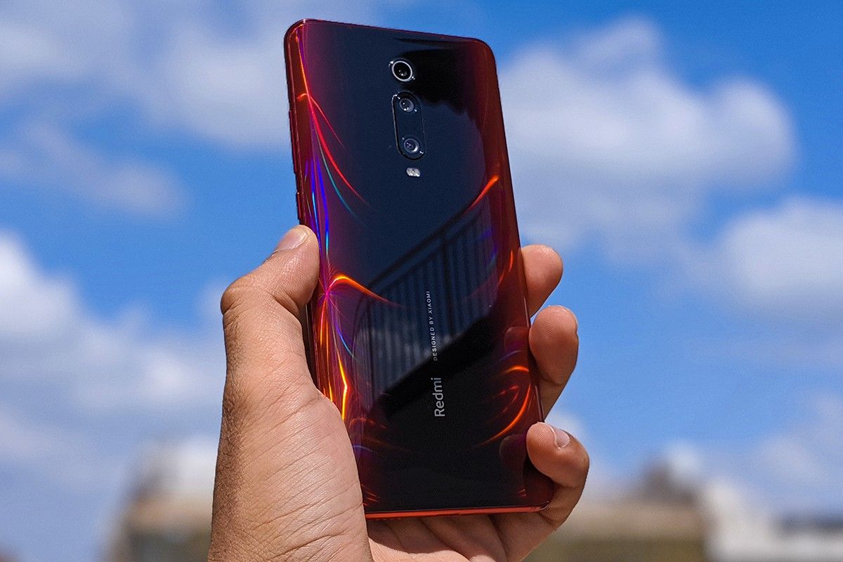 Red Redmi k20 pro in hand with sky in the background