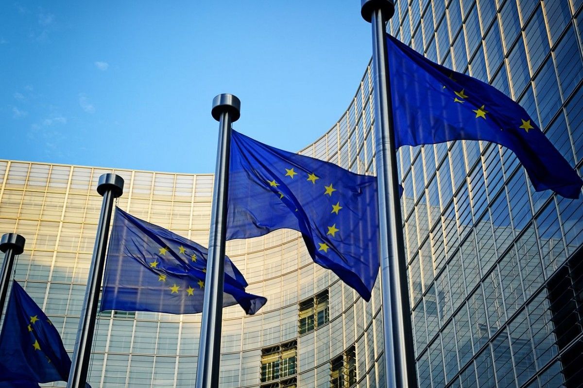 European Union flags with building in the background.