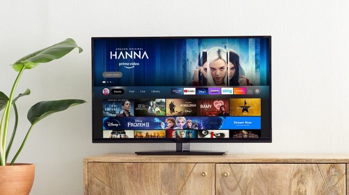 Revamped Amazon Fire TV UI on TV kept on a wooden table
