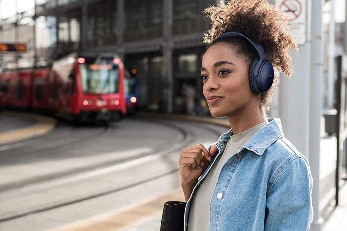 bose qc35 II headphones worn by woman walking down street