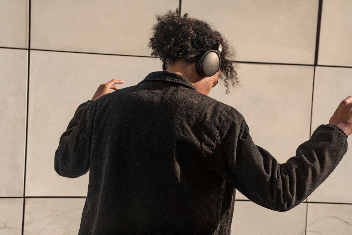 sennheiser 458BT headphones person wearing and dancing on ceggshell white background