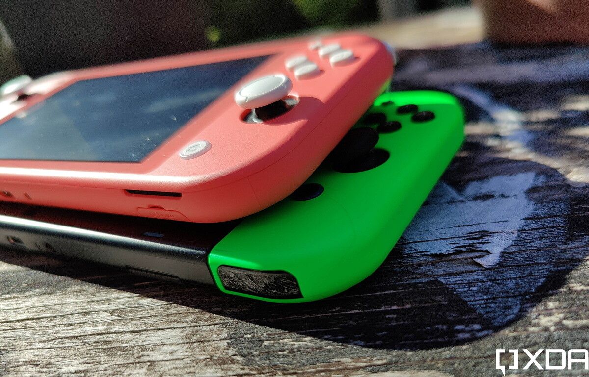 nintendo switch and switch lite on top of each other, outside