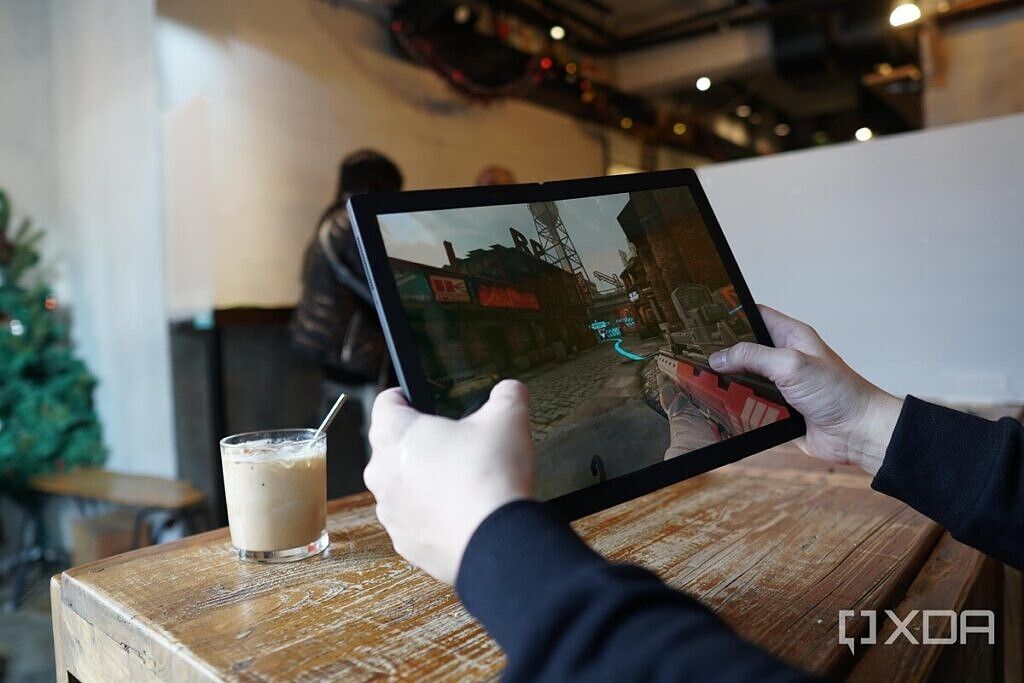 A Lenovo ThinkPad X1 Fold tablet running a first-person shooter game