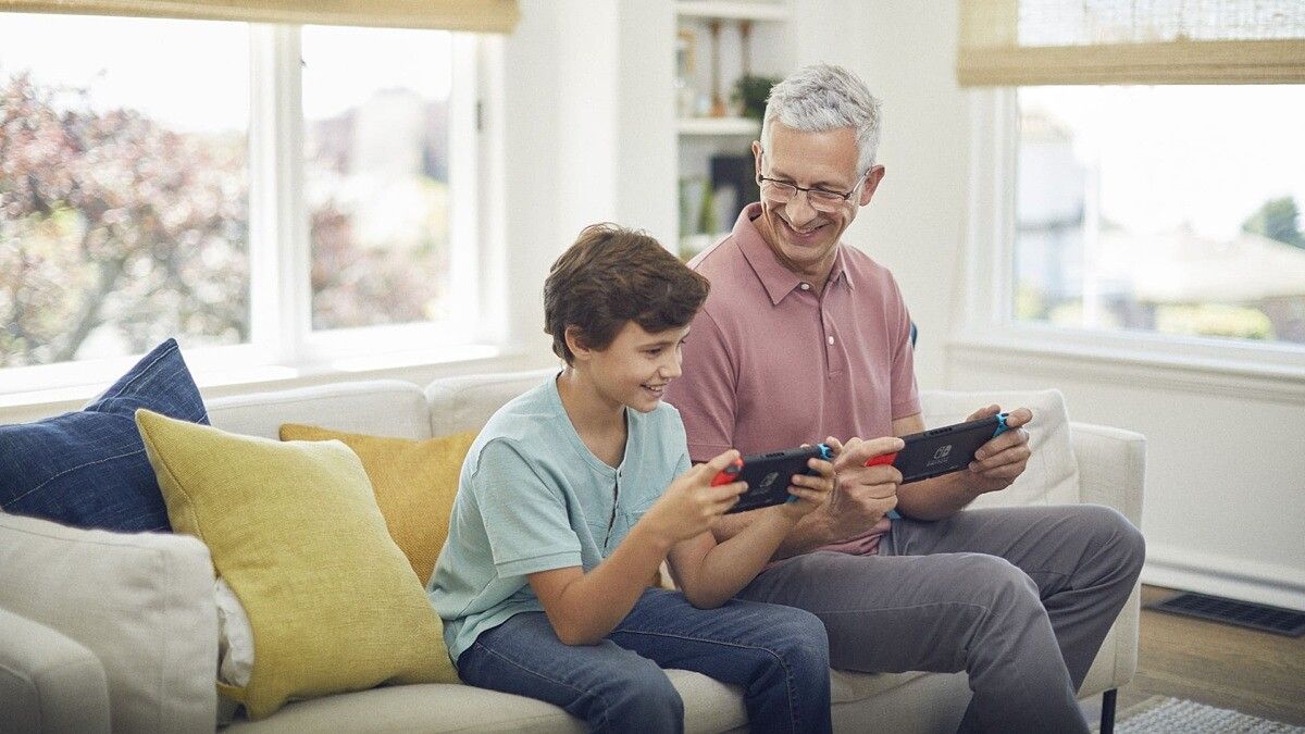 Man and boy play switch next to each other