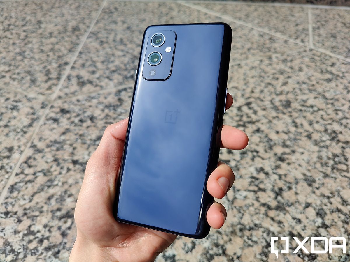 OnePlus 9 in hand showing off Astral Black back color