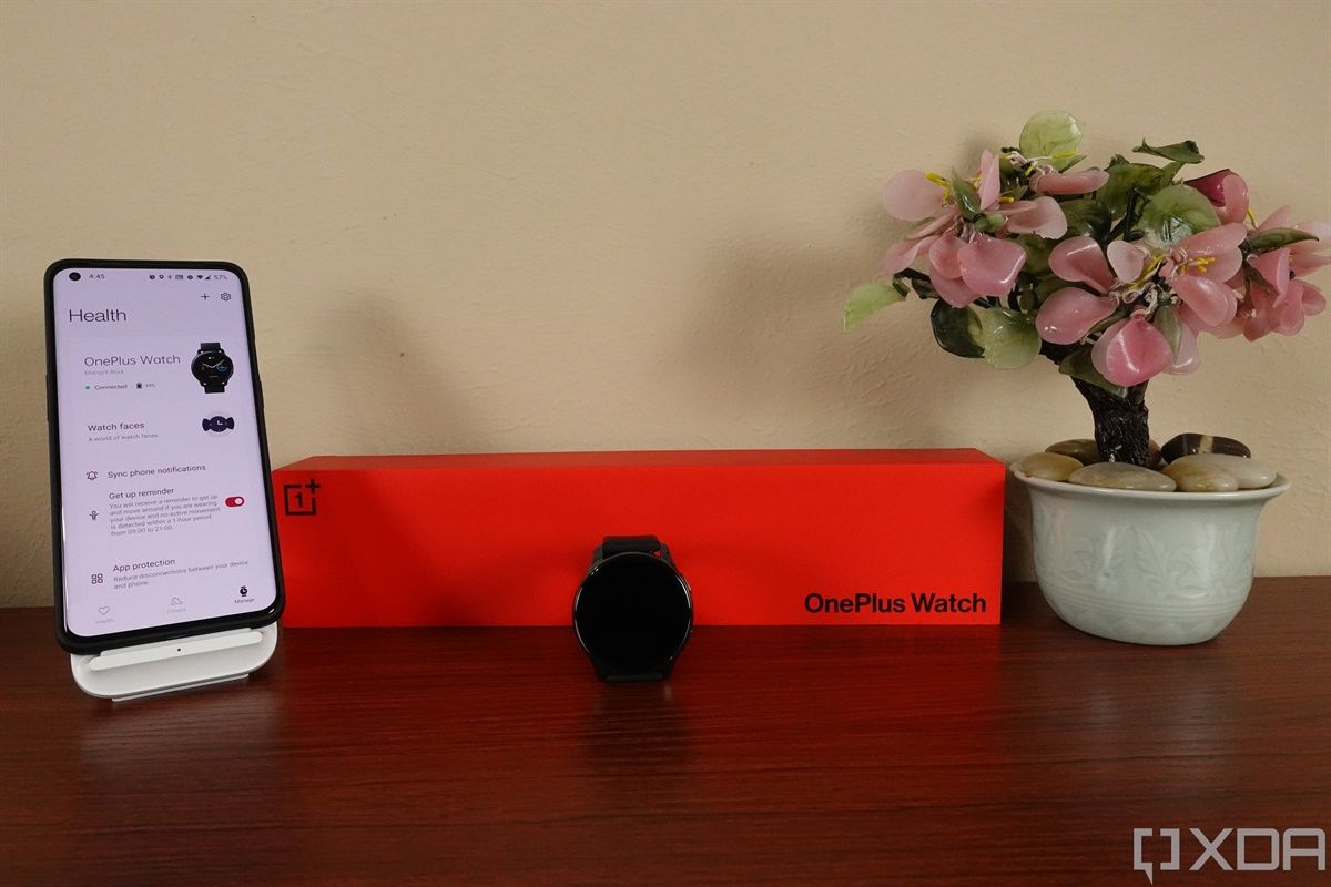 OnePlus Watch next to box and OnePlus 9 Pro