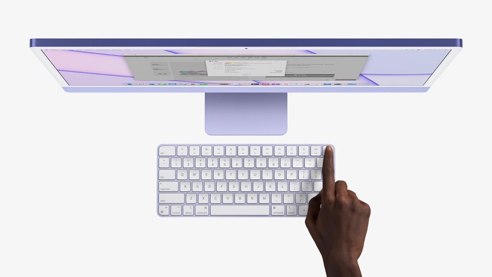 iMac and Magic Keyboard with hand pressing Touch ID