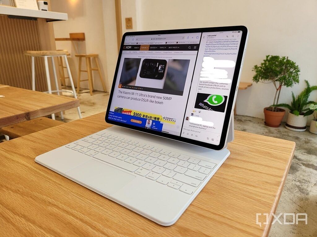 The 2021 iPad Pro with M1 chip with a white Magic Keyboard on a table. 