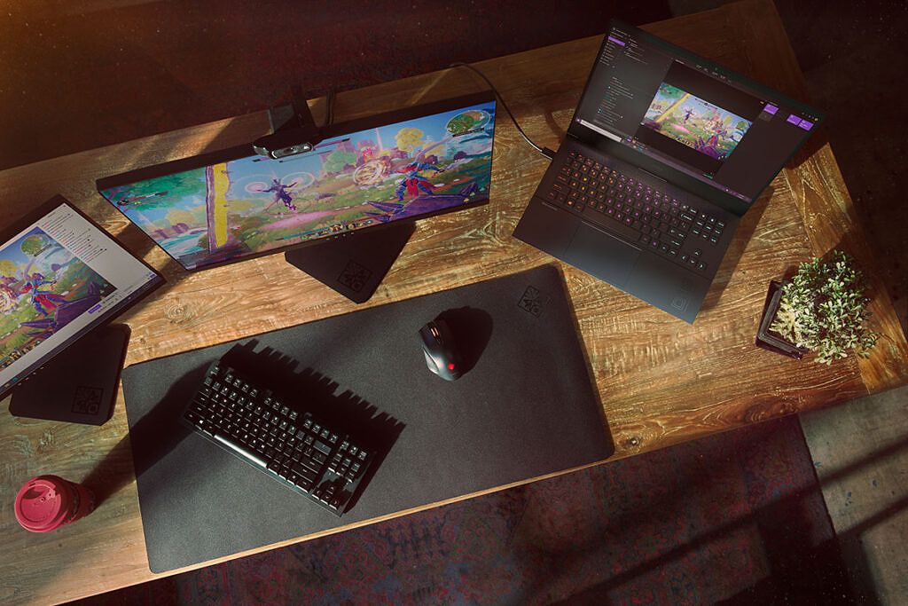Top-down view of HP OMEN 16 on desk with monitor and keyboard