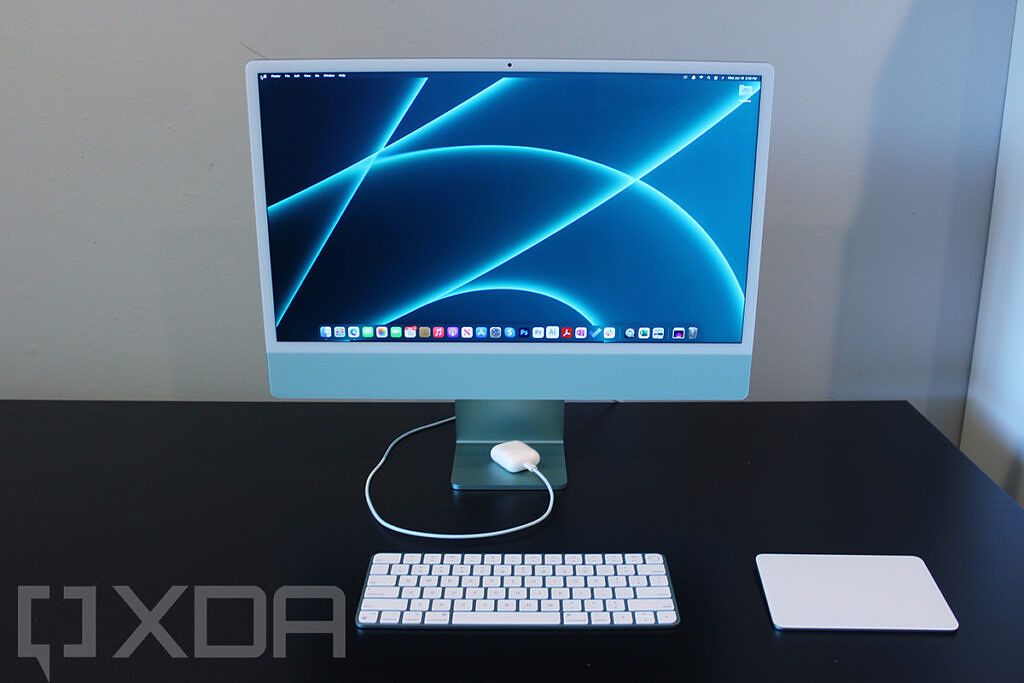 Front view of 24-inch iMac with keyboard, mouse, and AirPods