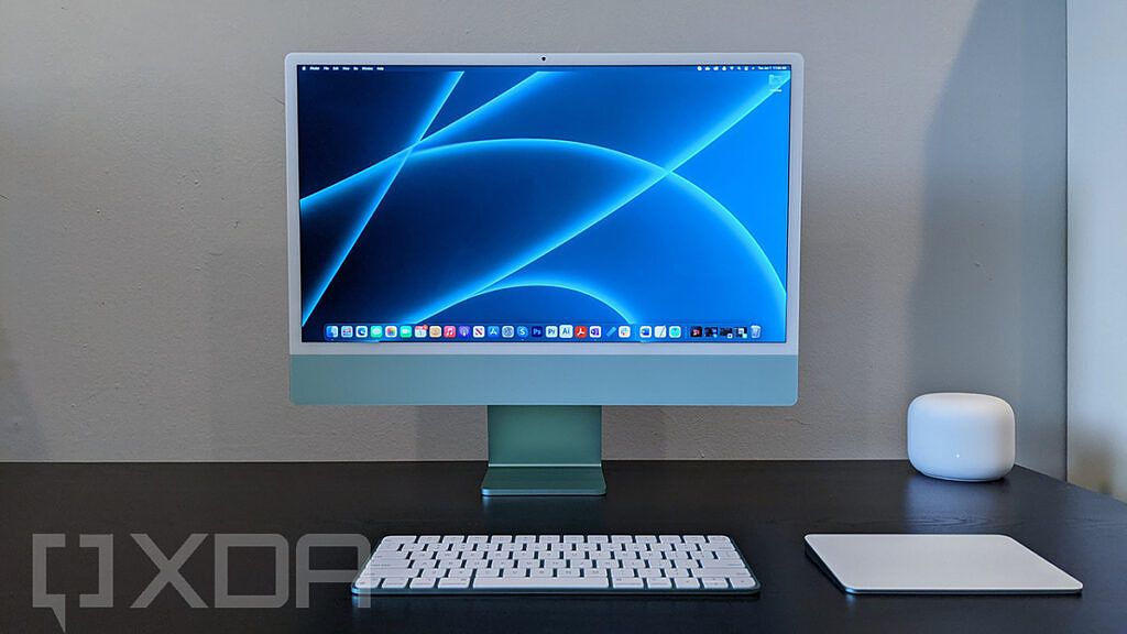 Front view of 24-inch iMac in green with keyboard and trackpad