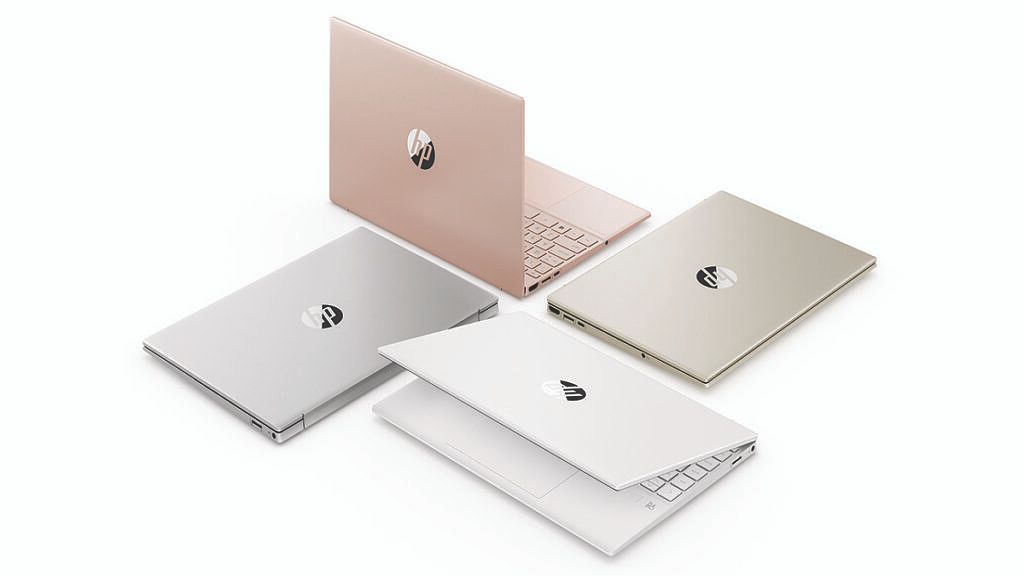 Four HP Pavilion Aero laptops in solver, gold, white, and pale rose gold.