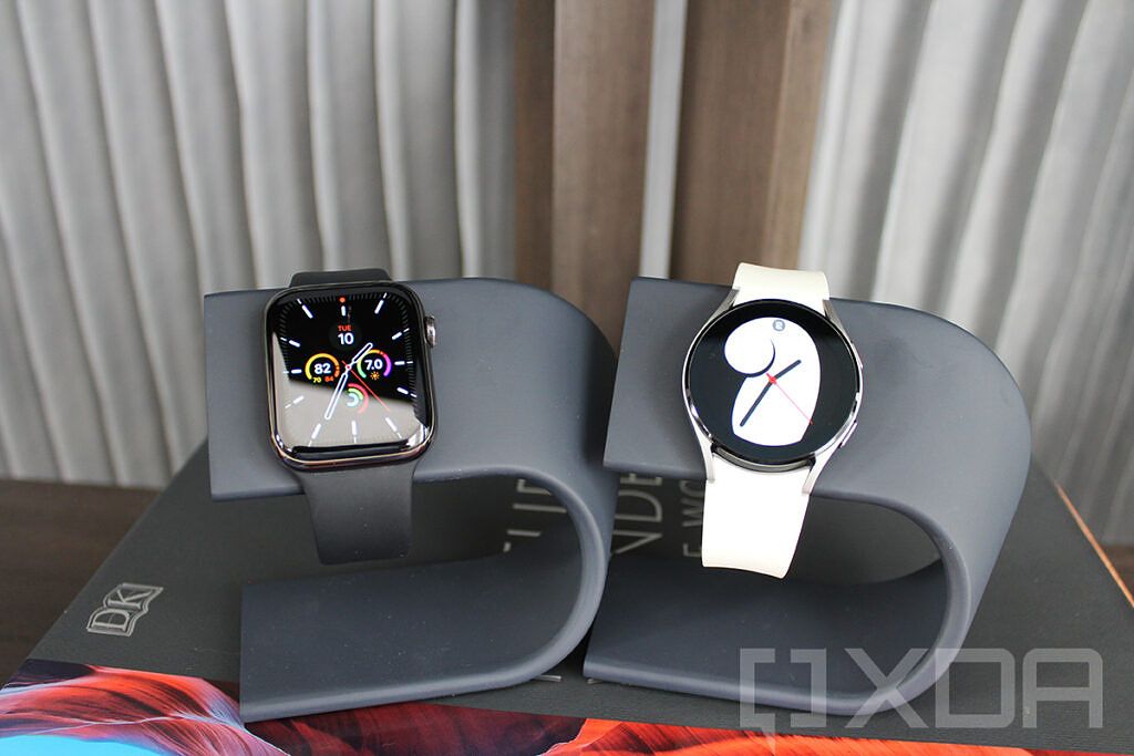 Apple Watch and Samsung Galaxy Watch 4 on watch stands