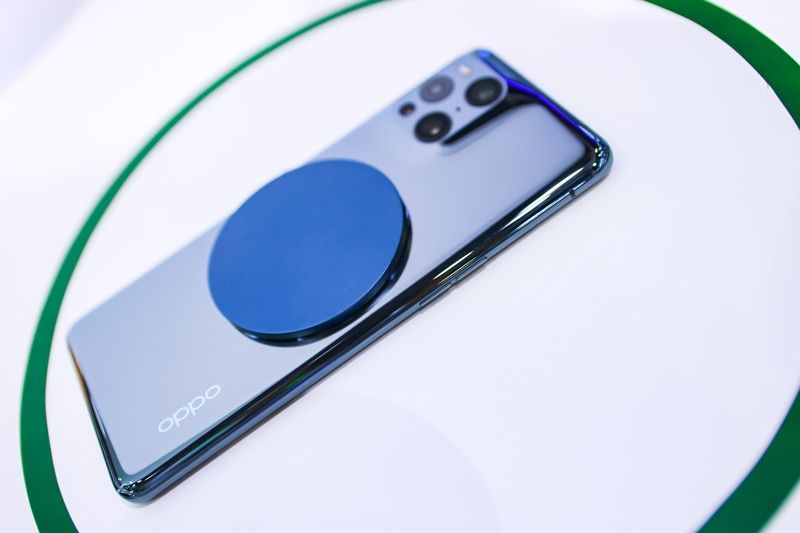 OPPO's 20W MagVOOC charging pad attached on the back of a smartphone
