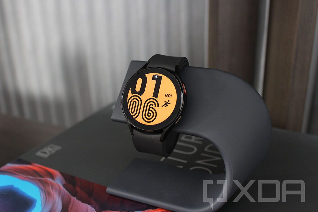 Samsung Galaxy Watch 4 in black with orange watch face