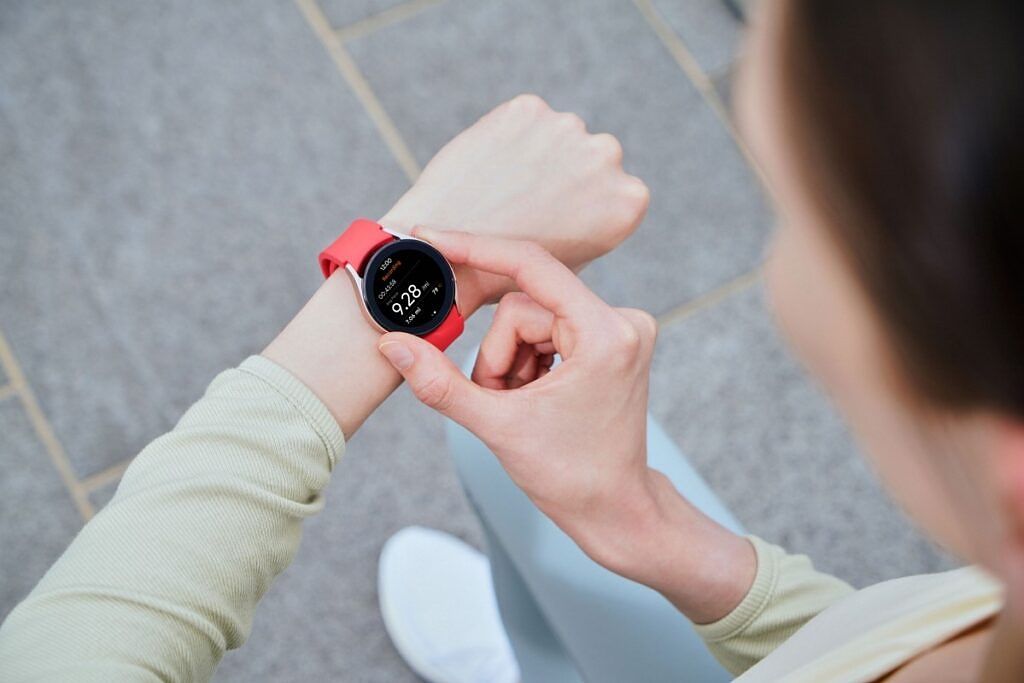 Samsung Galaxy Watch 4 with red bands on wrist