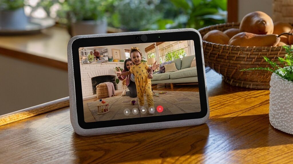 Facebook's Portal Go smart display sitting on a table with the screen showing an on-going video call