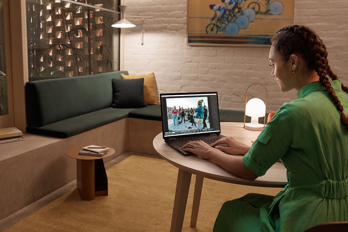 Woman sitting and using HP Spectre x360 16