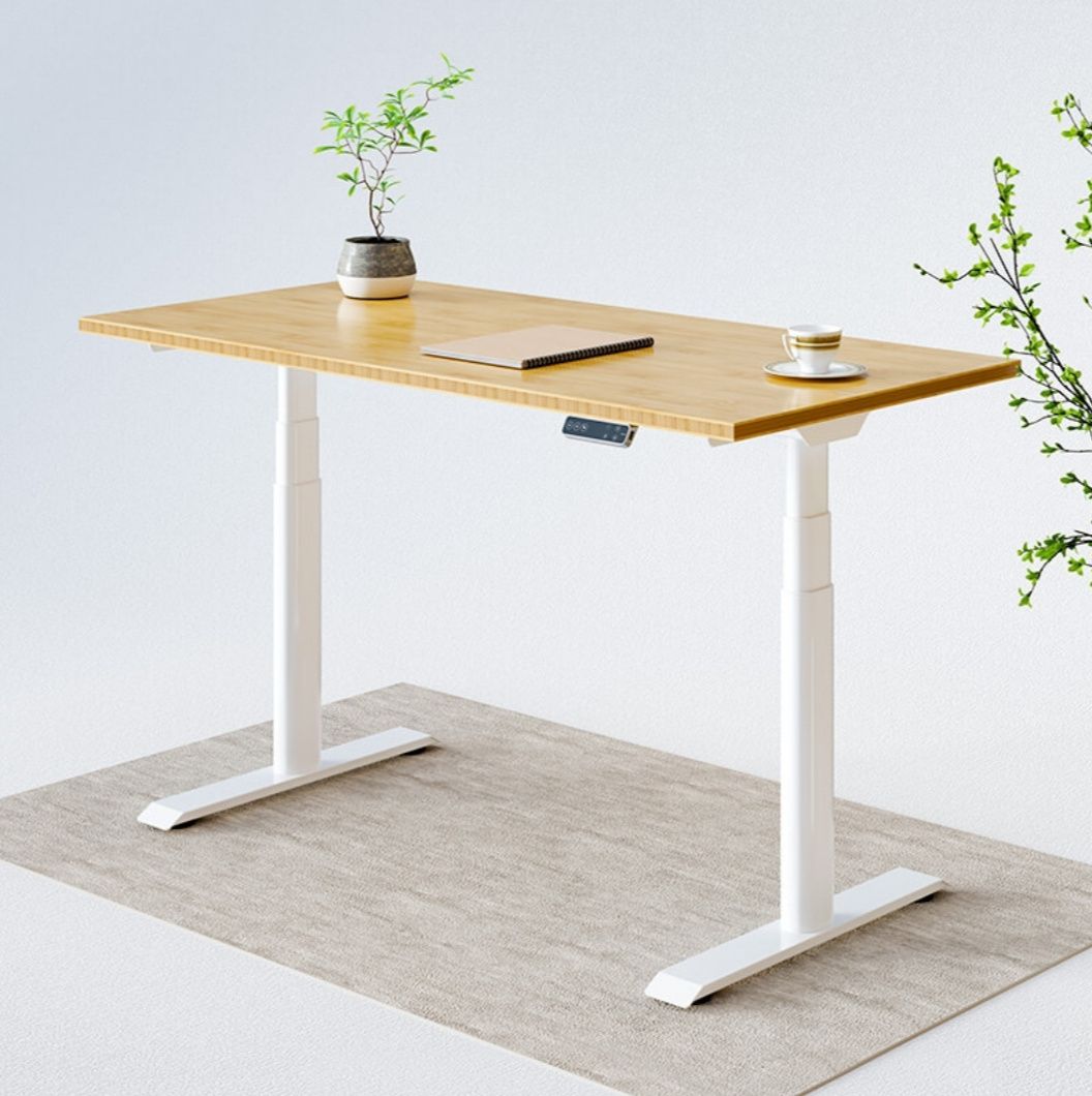 Desk with notebook and plant on gray carpet