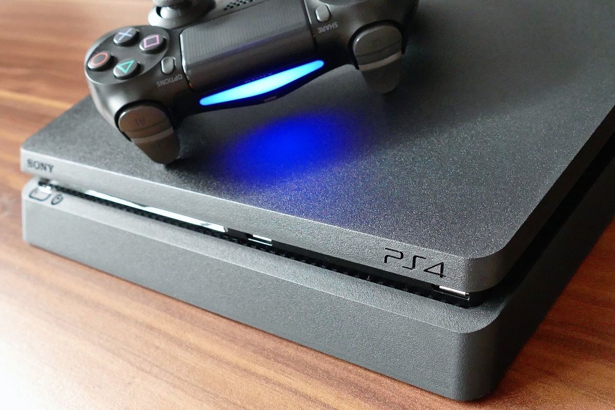 front of a playstation 4 with a controller on top, spine emulates the playstation 4