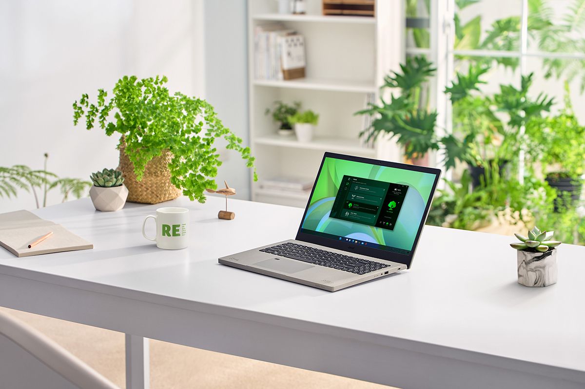 Laptop on white table with plants