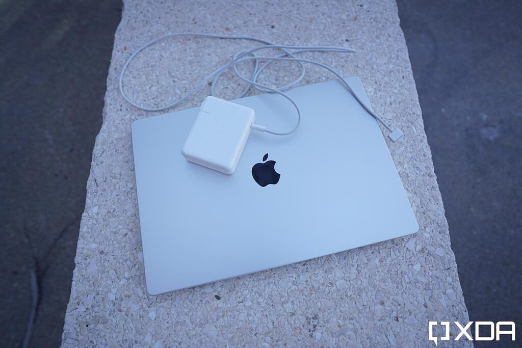 MacBook Pro with its 140W charging brick. 