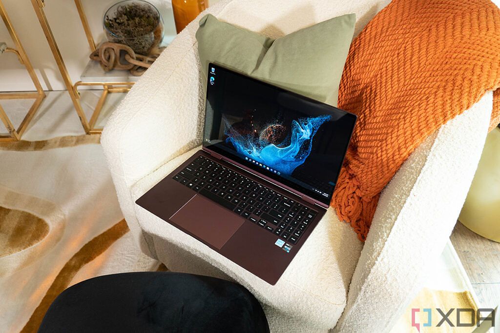 Samsung Galaxy Book 2 Pro 360 in Burgundy resting on a chair with the lid open at about 90 degrees