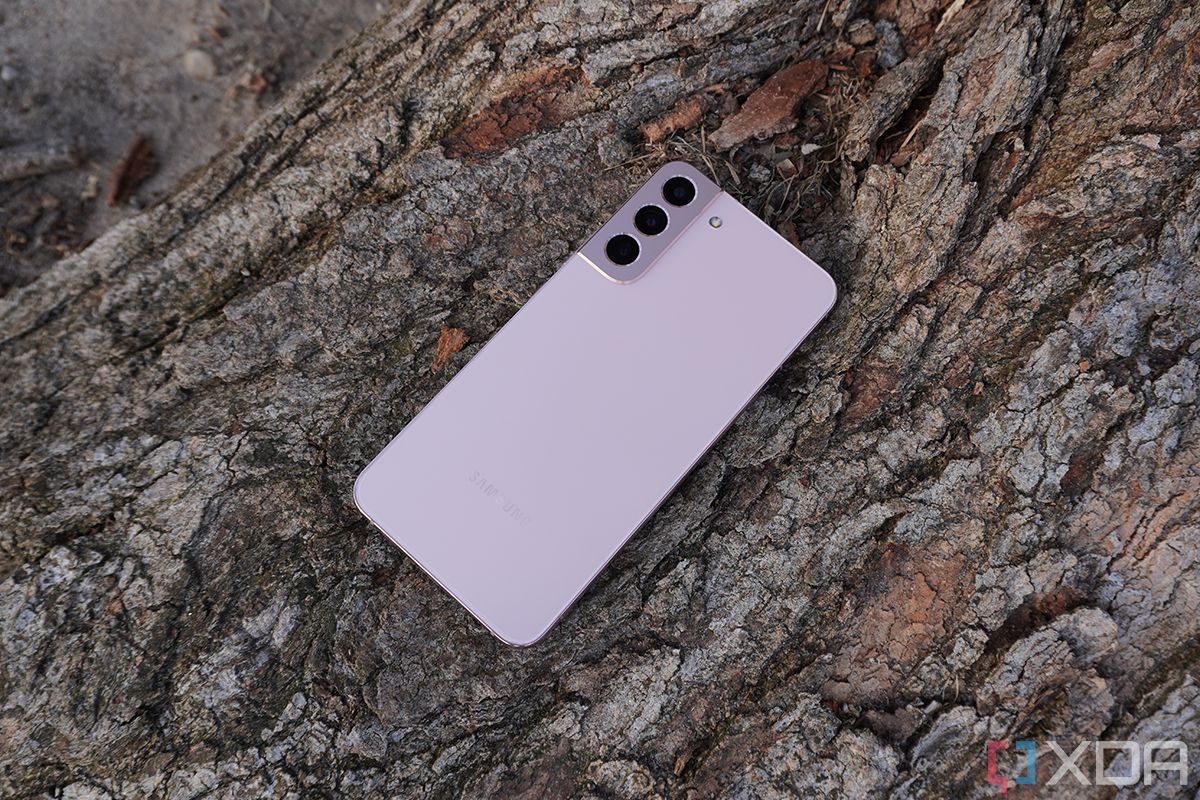 A Samsung Galaxy S22 Plus showng from the back lying on a tree