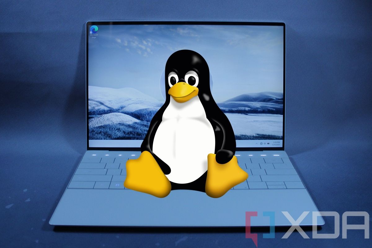 Linux mascot on top of Dell XPS 13 Laptop with lid open