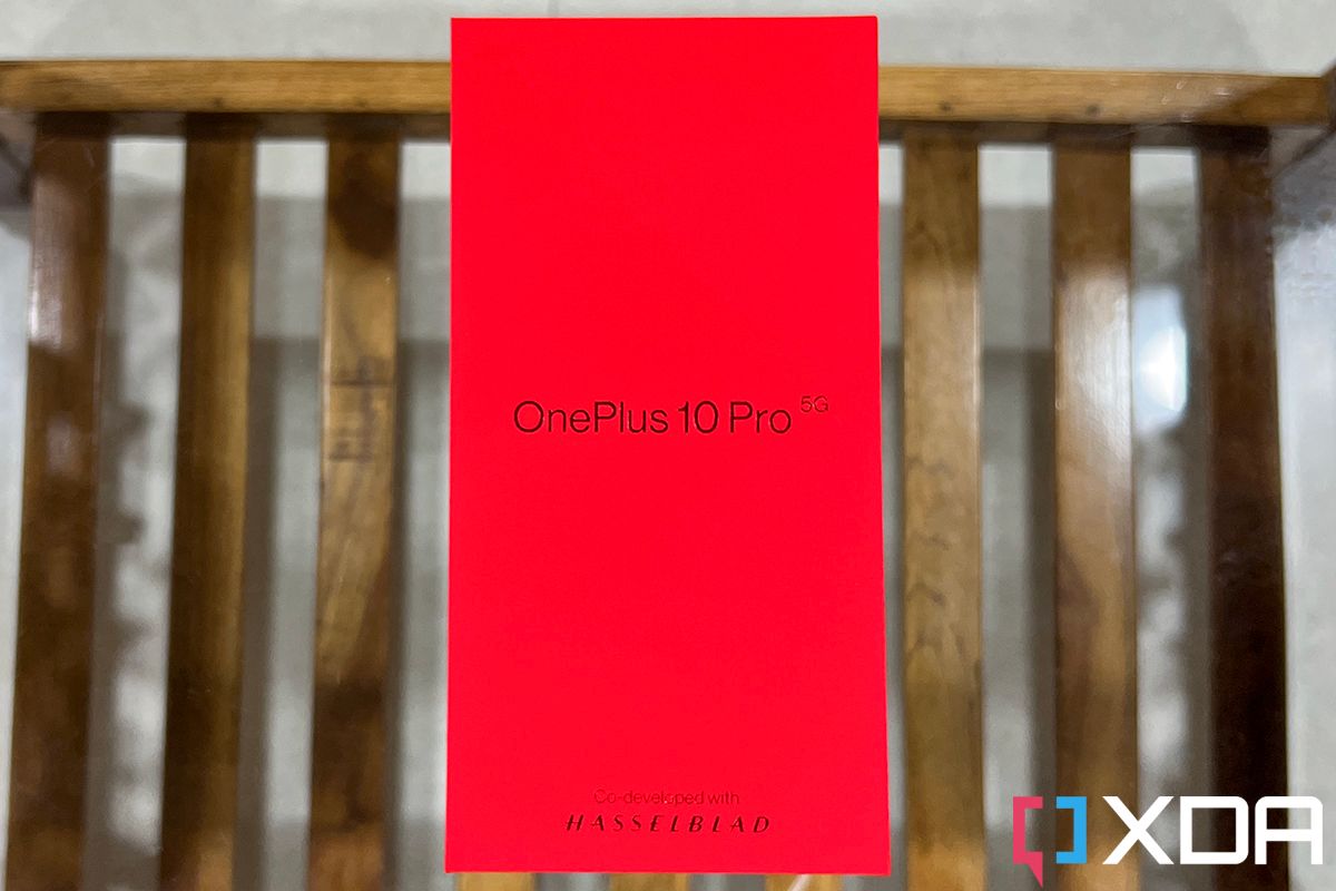 Red box of the OnePlus 10 Pro kept on a wooden table with glass top