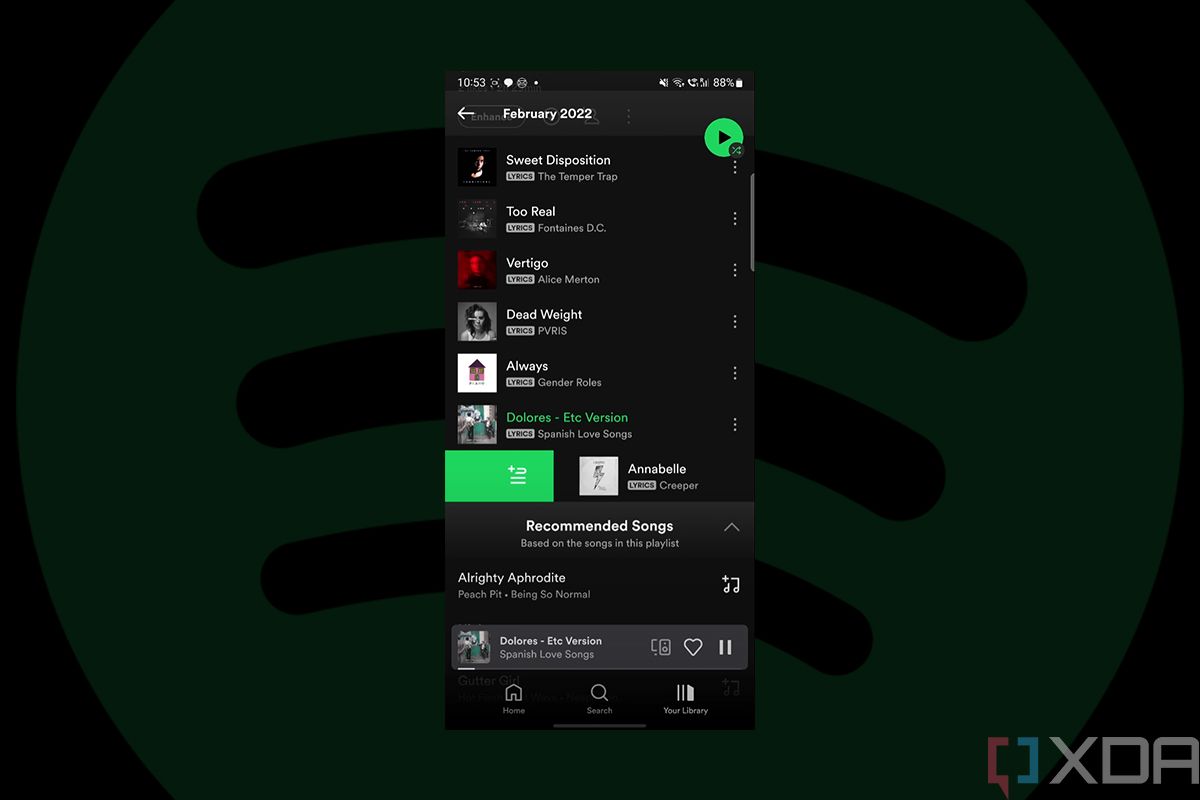 Screenshot showing Spotify's Swipe to Queue gesture on black background with translucent Spotify logo