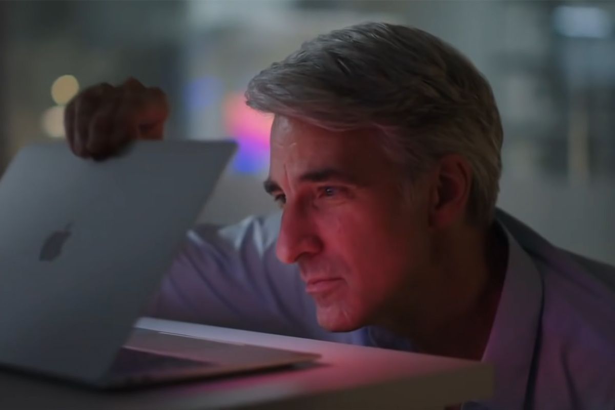 Craig Federighi looking at inside of a Mac