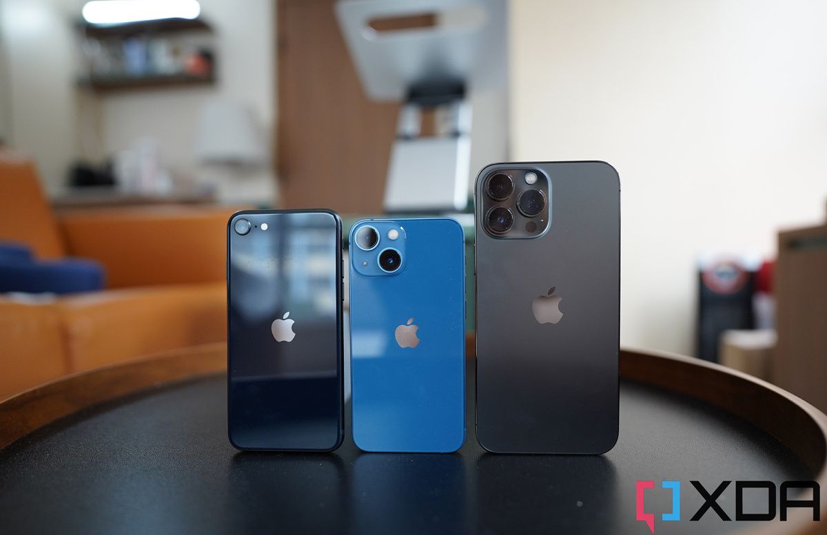 Different iPhones on a round table.