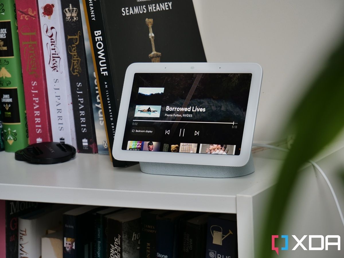 Google Nest Hub 2nd Generation on a white shelf with books