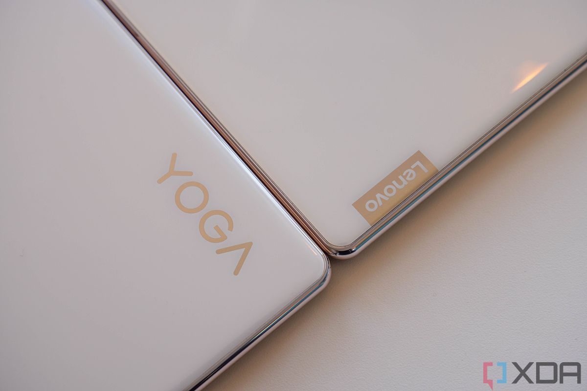 Lenovo and Yoga logos on white laptop lids