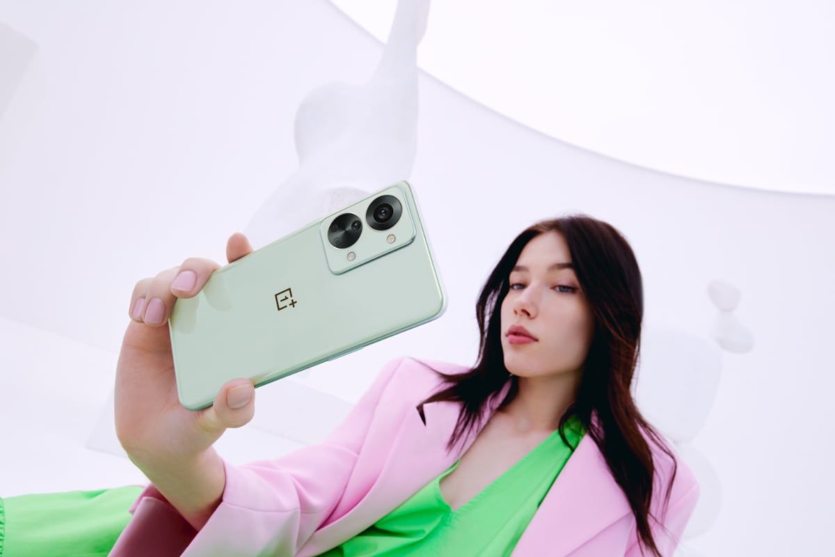 Green OnePlus Nord 2T in model's hand