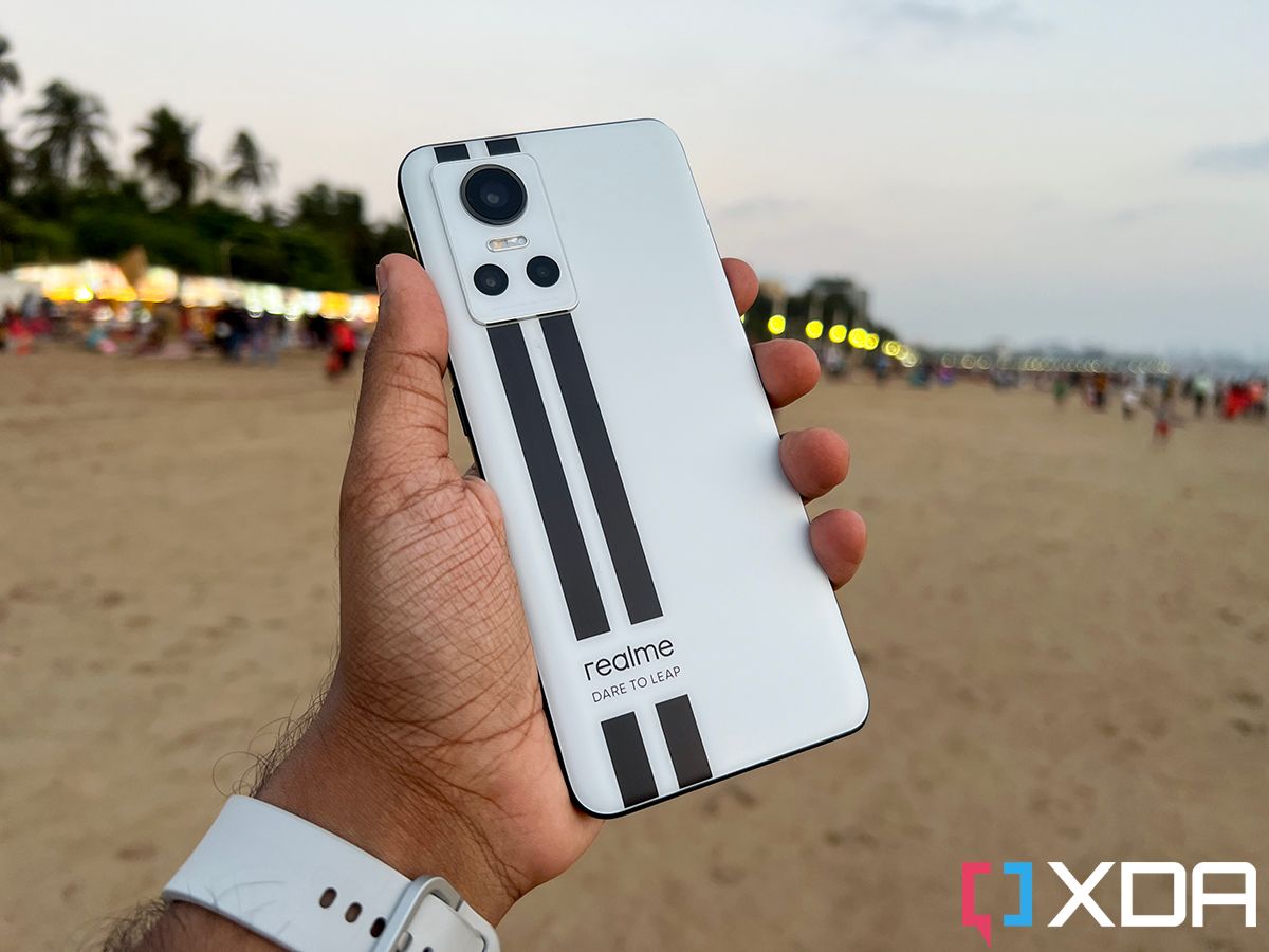 Realme GT Neo 3 in White color against the backdrop of a beach
