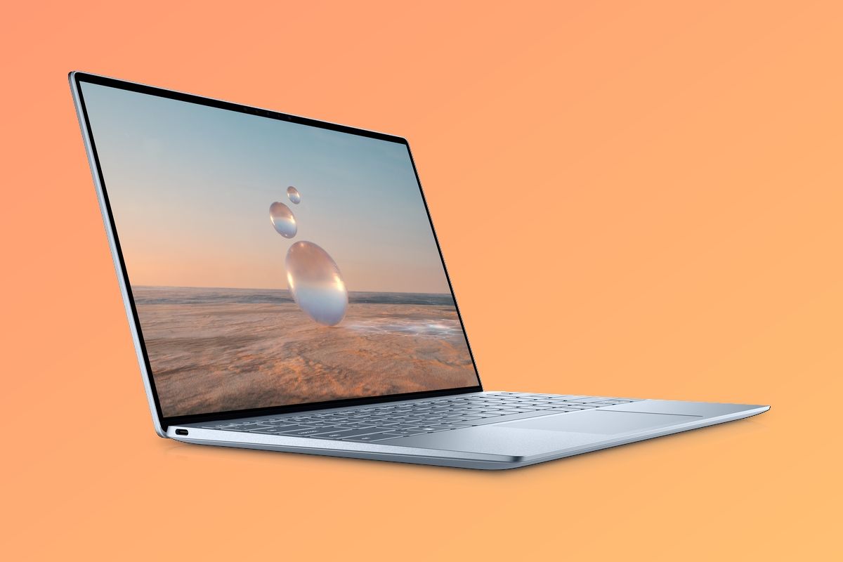 Dell XPS 13 in light blue over a gradient orange background