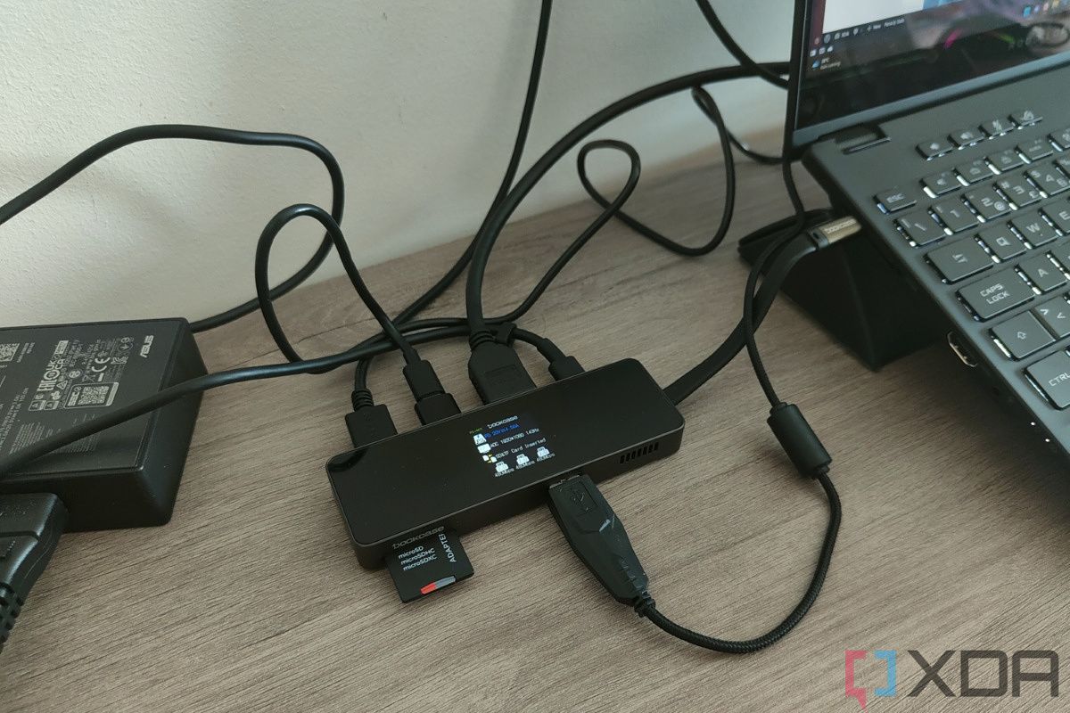 Angled view of the DockCase USB-C Visual Smart Hub 7-in-1 connected to multiple peripherals and a laptop