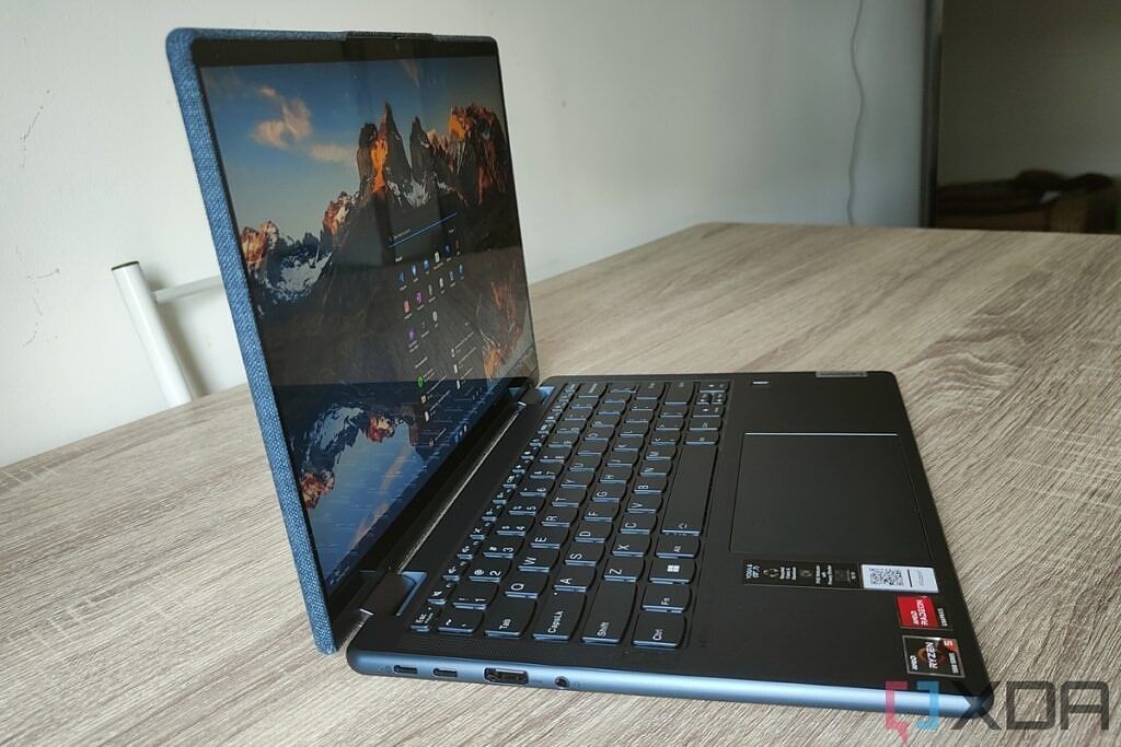 Angled left-side view of the Lenovo Yoga 6 Gen 7 with the lid open showing two USB Type-C ports, an HDMI port, and a headphone jack.