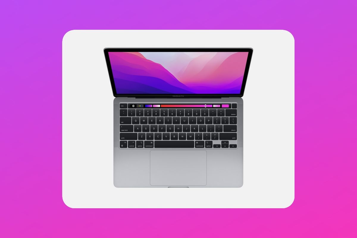 Overhead view of MacBook Pro 13 2022 over a purple and pink gradient