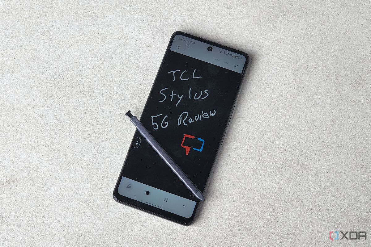 TCL Stylus 5G on a white table with the stylus on the screen.