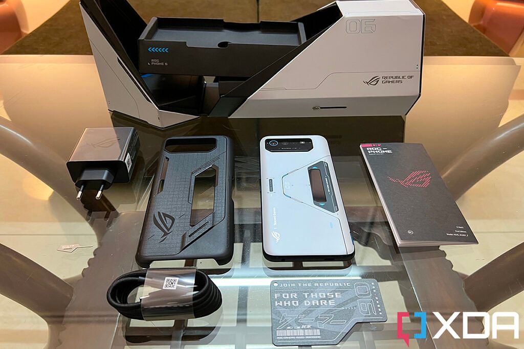 Box pack of the Asus ROG Phone 6 Pro, showing the contents: charger, sim ejector tool, USB Type C to C cable, a case, the ROG Phone 6 Pro phone, an AR card, and some documentation