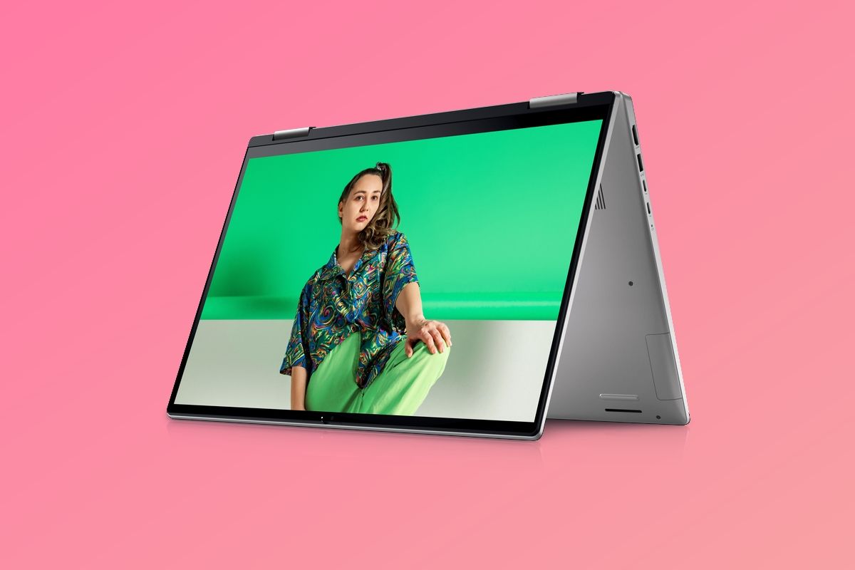 Dell Inspiron 16 2-in-1 in tent mode over a pink background