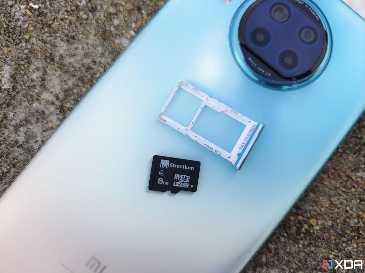 SIM tray with a microSD card slot resting on phone's back