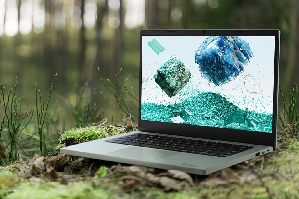 Angled view of the Acer Chromebook Vero 514 in the middle of a forest