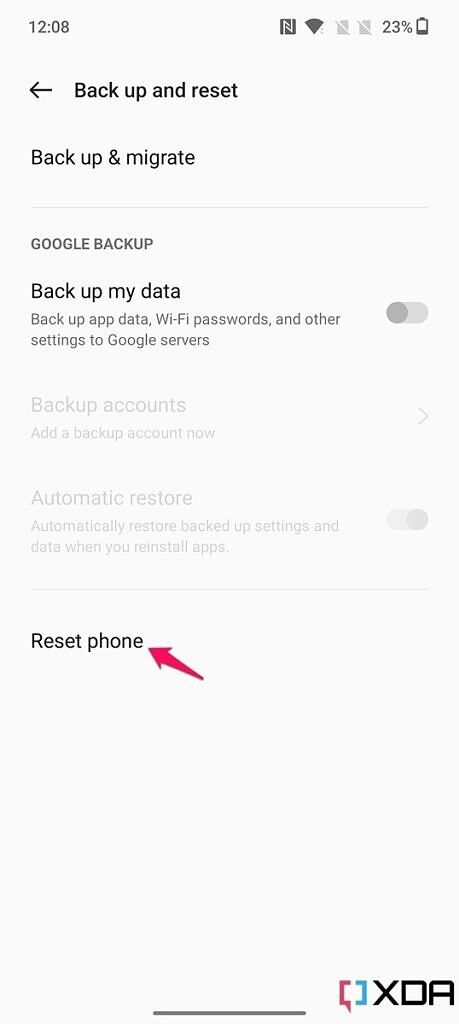 Screenshot of Back up and reset menu on the OnePlus 10T with pink arrow pointing at the Reset phone option.