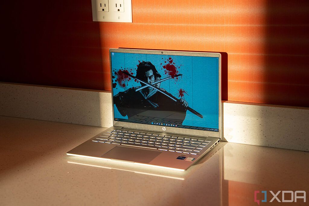 Angled view of HP Pavilion Plus with Lone Wolf and Cub wallpaper