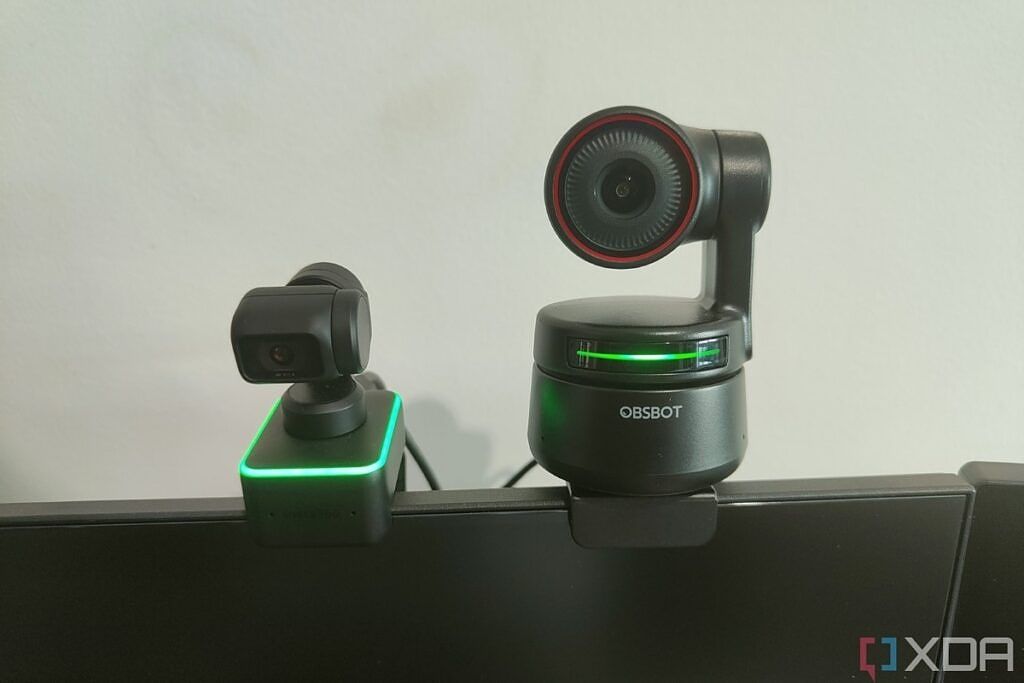 Insta360 Link webcam next to the Obsbot Tiny 4K webcam, both mounted on a monitor.